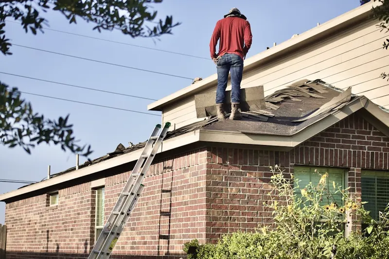 Professional roofer working on a residential roof in Ho-Ho-Kus